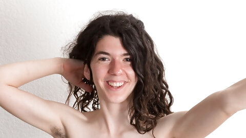 Playful American Silki Smith strips to her heels and exposes her hairy crotch