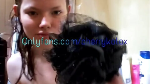 Brunette hair takes washroom rubbing soap all over body.